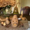 A mushroom house made from natural gourds. The original gourd stem on the top. A "Toad Stool Inn" house sign hangs on the side. 